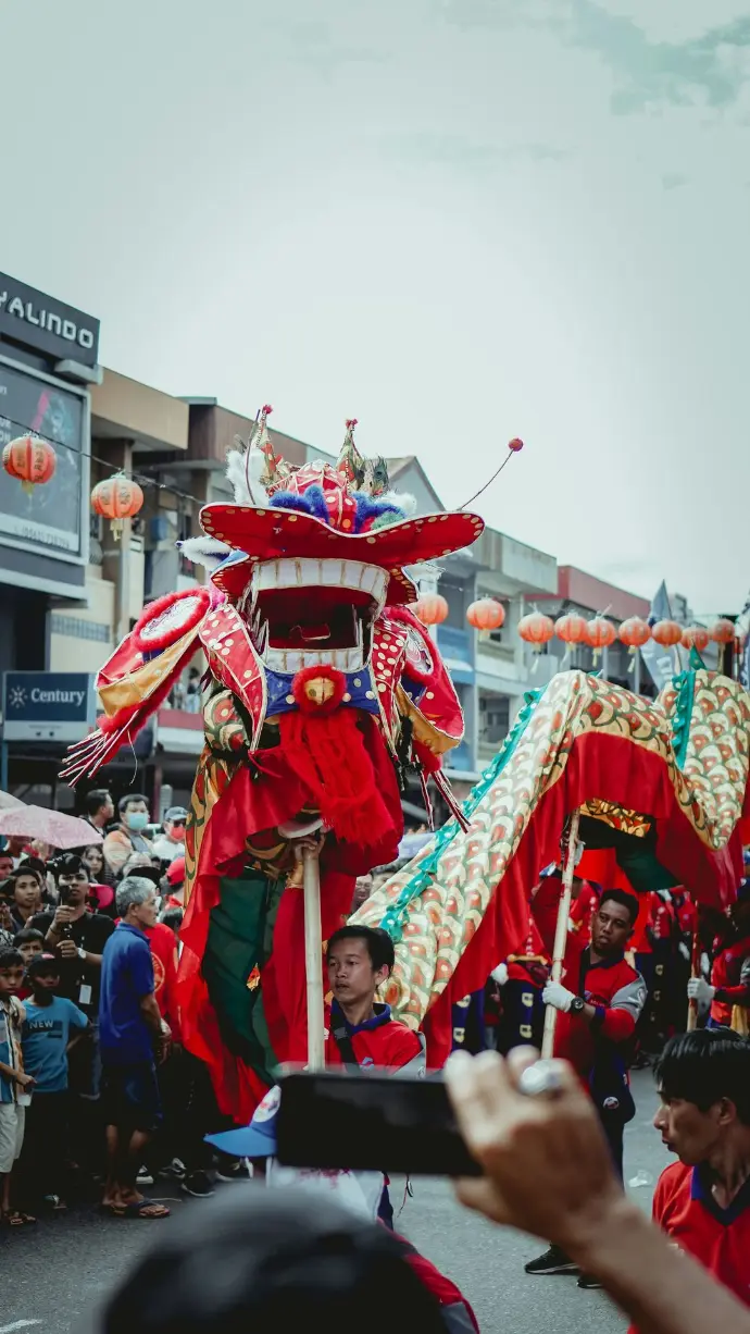 people in red and gold costume standing on street during daytime
